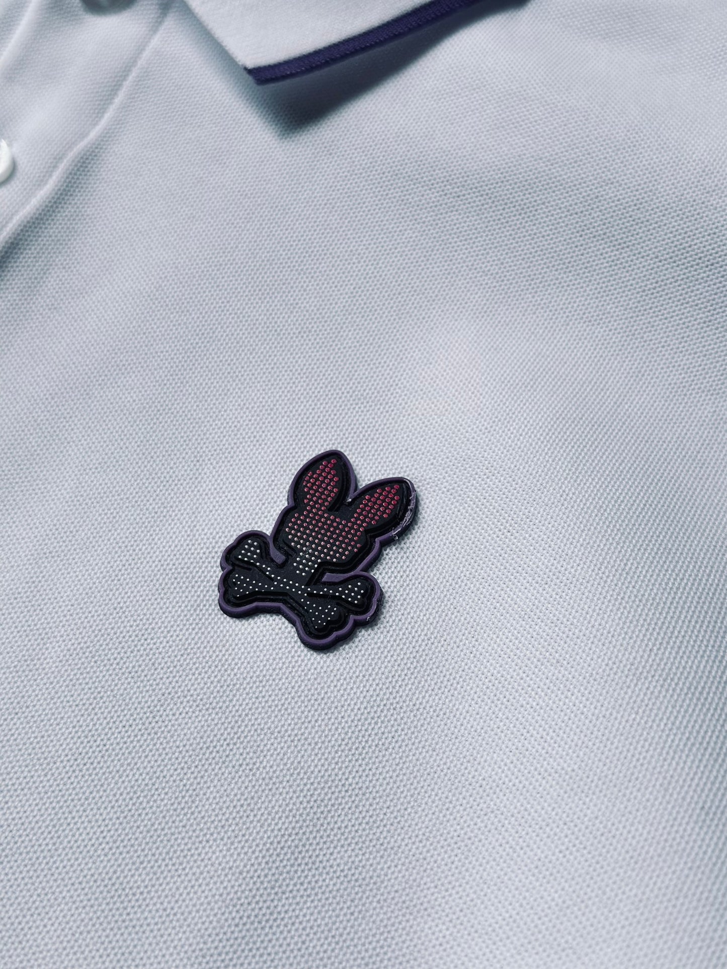 CAMISETA POLO PSY BLANCA LINEA MORADA