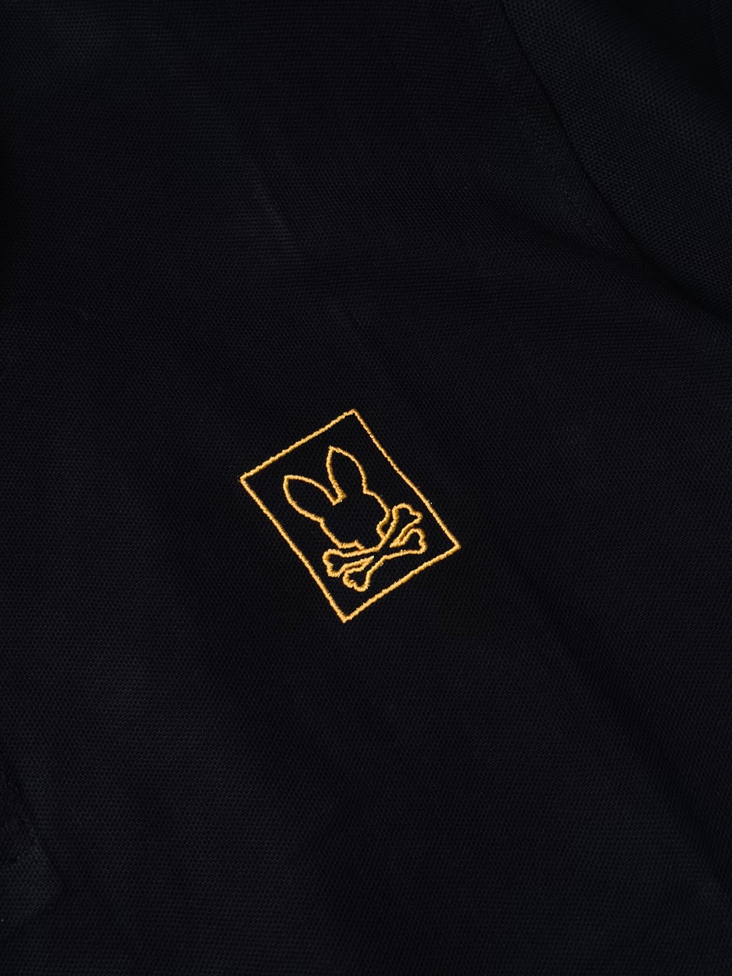 CAMISETA POLO PSY NEGRA BORDE NARANJA