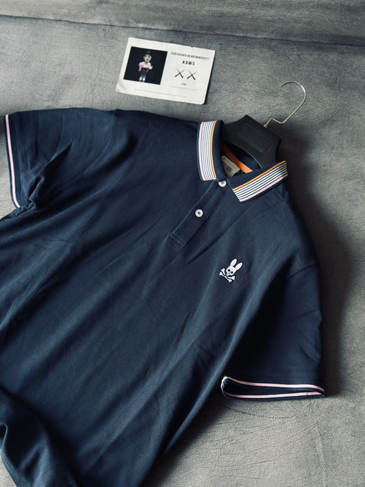 CAMISETA POLO PSY AZUL CUELLO NARANJA ROSADO